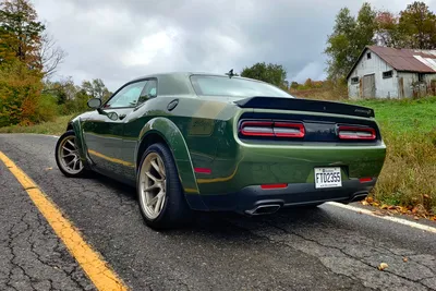 Front view of a dodge challenger in a foggy night on Craiyon