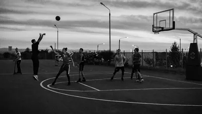 Male teen basketball player dribbling the ball on an outdoor court during a  sunny day. Man athlete playing streetball. Stock Photo | Adobe Stock